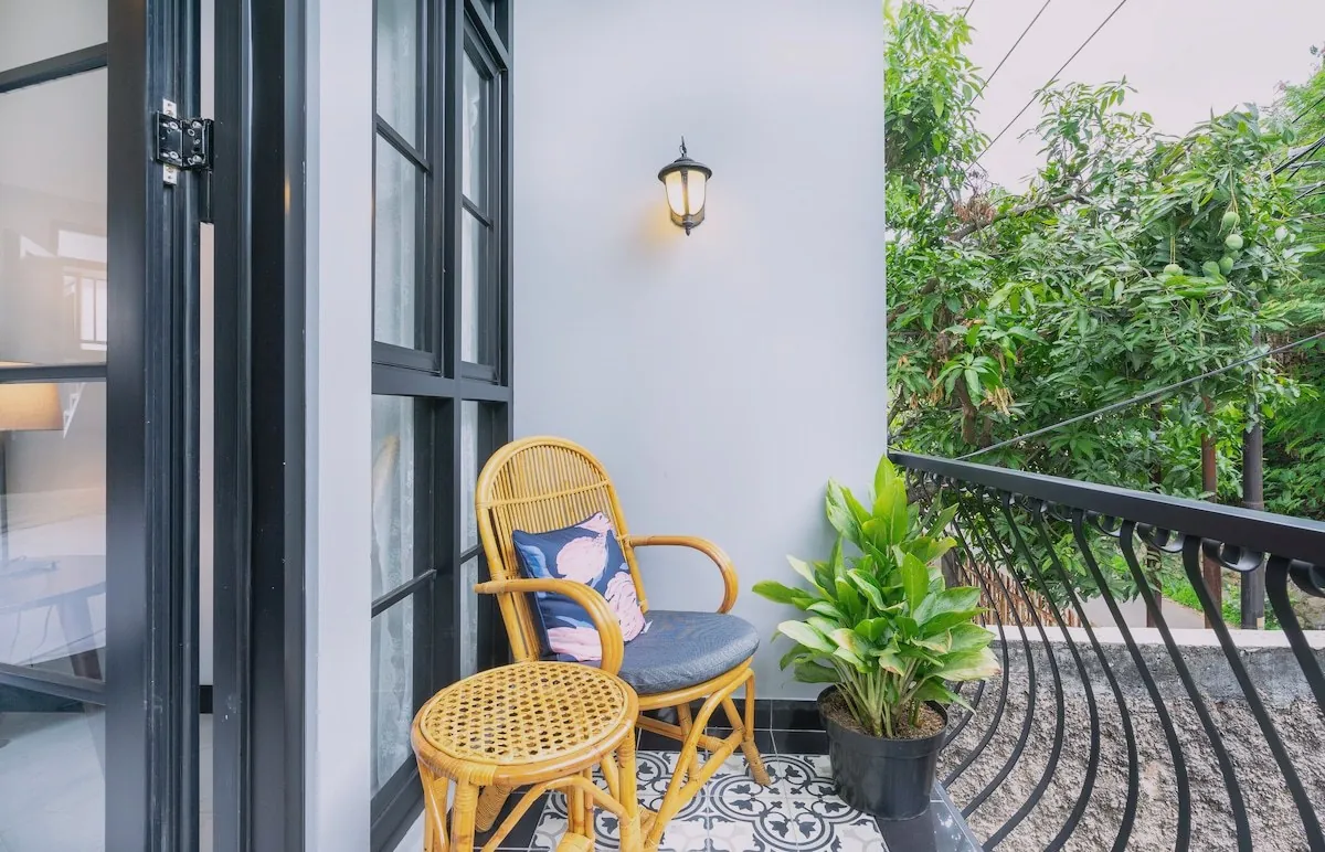 Outdoor patio surrounded by mature cactus and flowers